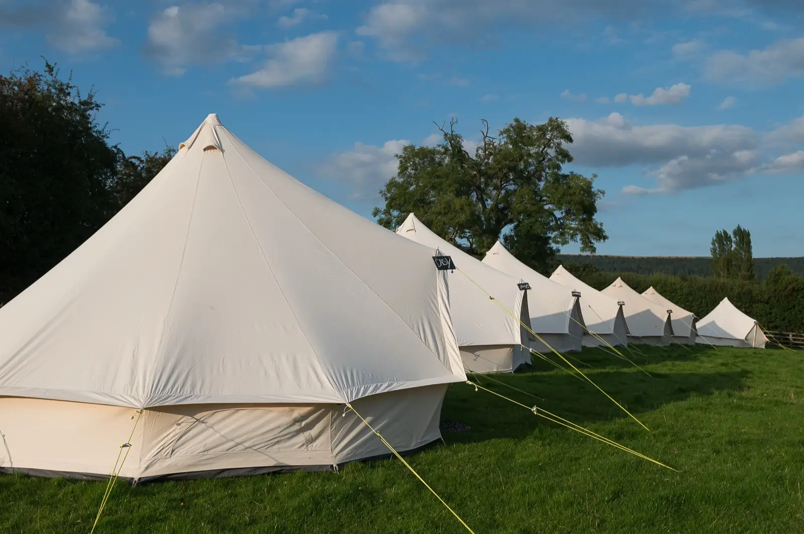 Row of bell tents lined up at an event
