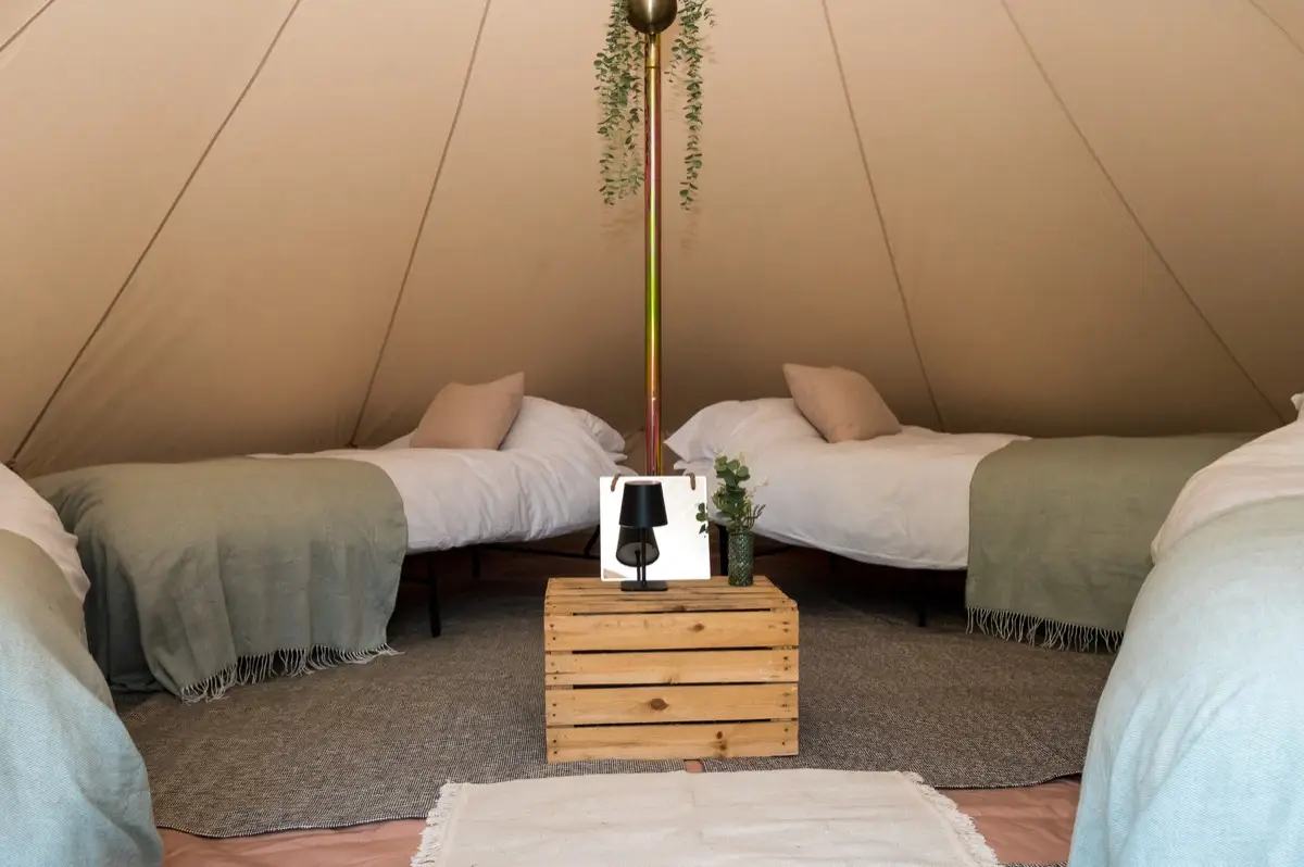 Real beds made up inside a 7m XL bell tent